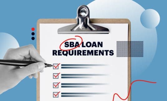 A hand holding a pen fills out a form labeled “SBA Loan Requirements.”