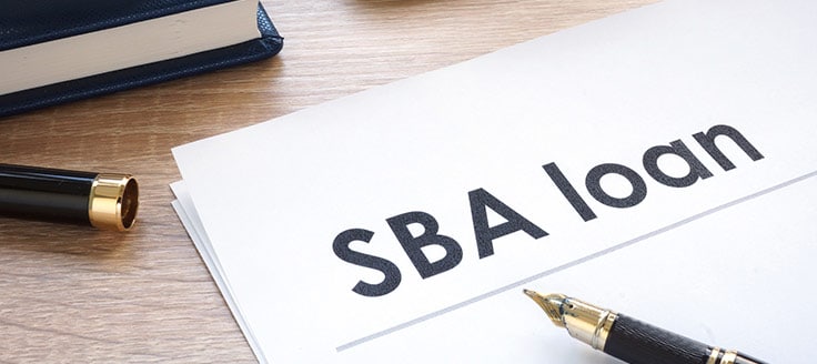 An SBA loan document rests on a desk.