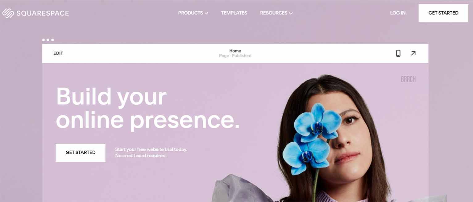Squarespace’s home page features a purple background, an image of a woman holding a blue flower over 1 eye and the words “Build your online presence.”