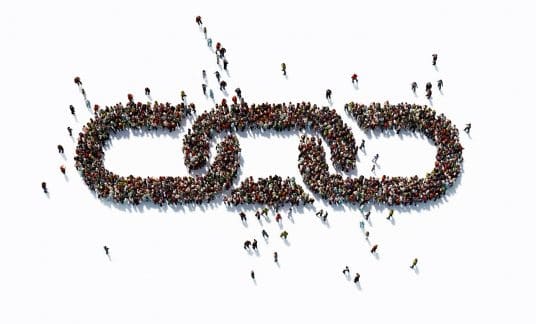 A crowd of people forming links in a chain.