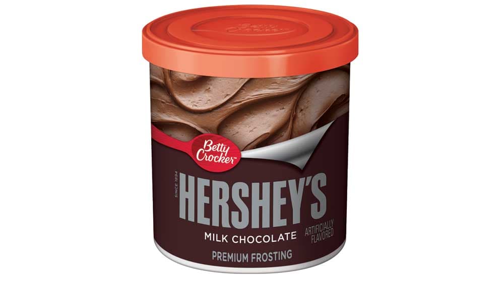 A container of milk chocolate frosting branded with the Betty Crocker and Hershey’s logos.