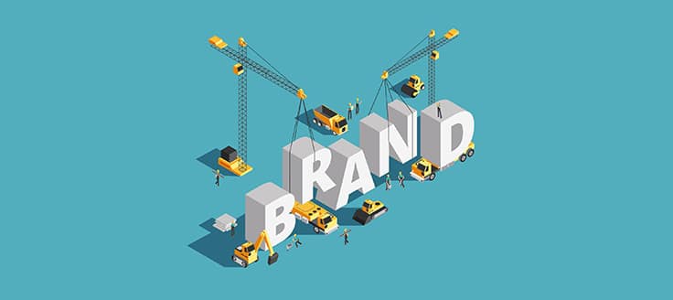 Construction vehicles and equipment put large letters spelling "Brand" in place in this concept illustration of brand building.