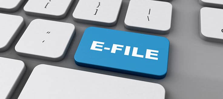 A blue key labeled “e-file” is on a computer keyboard. You can file your articles of organization online in certain states.