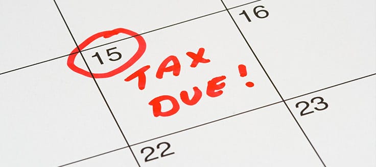 A calendar has the 15th circled in red ink with the words “Tax due!” written on the date. Depending on your business structure, your Schedule K-1 deadline is March 15.