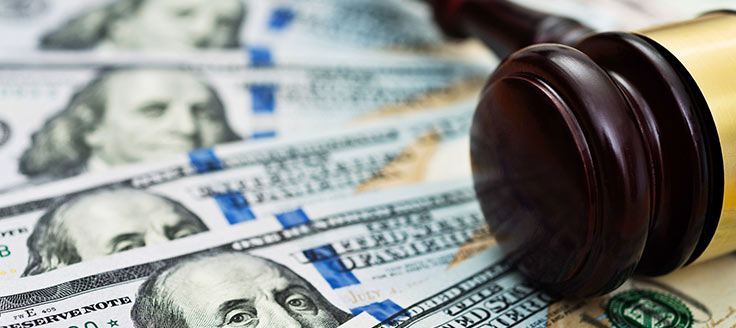 A gavel rests on an array of $100 bills. Costs vary for online legal services.