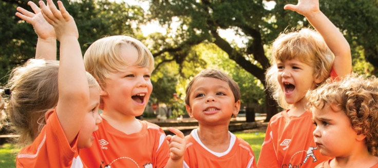 Members of a children’s soccer team cheer together. The Soccer Shots is an option for someone looking for a low-cost franchise to own.