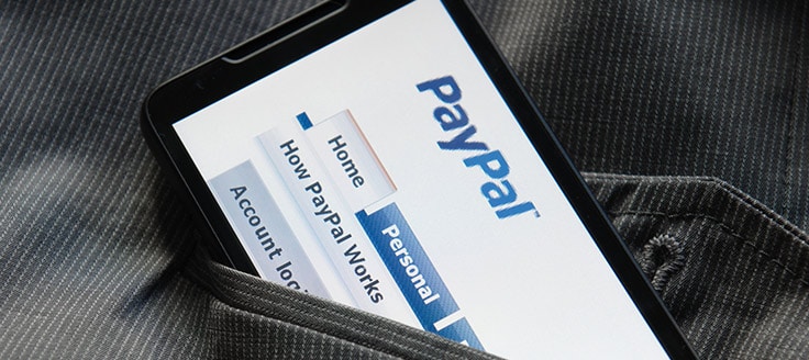 The PayPal mobile site is on a smartphone screen. PayPay is among the payment service providers your business can use to accept credit card payments.