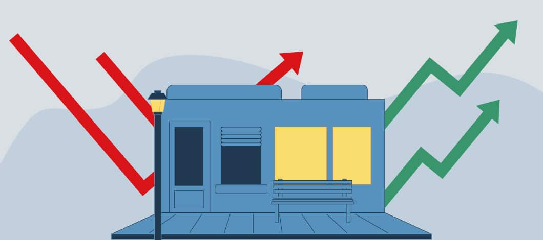 Red and green arrows move up and down around a commercial property in this concept illustration of MACRS depreciation.