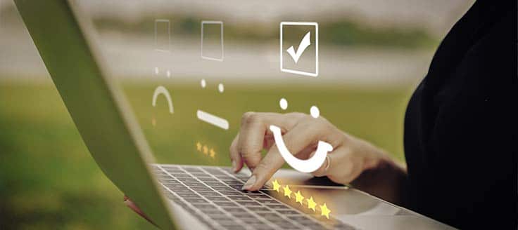 A woman sits outdoors and works on her laptop. Google Voice for Business works anywhere you can connect to your Google account.