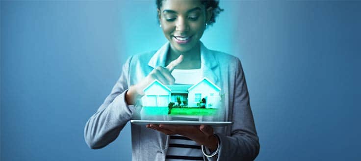 A woman holds a model of a house in her hands in this concept photo of real estate property showings.
