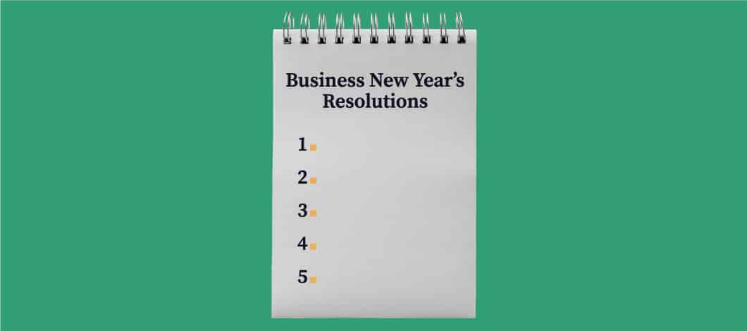 A spiral notepad with the words "Business New Year's Resolutions" and the numbers 1 through 5
