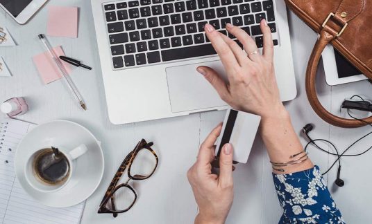 A woman makes credit card purchases for her business.