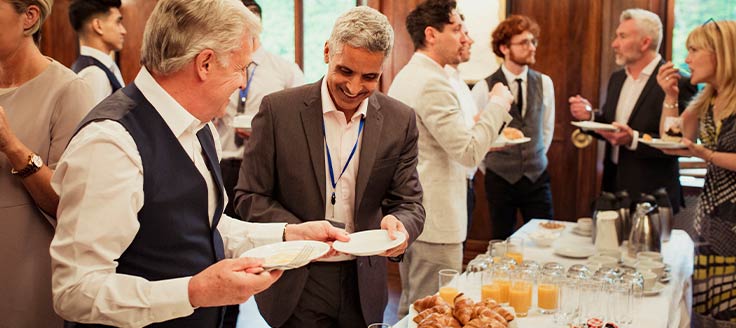 People attend a business networking breakfast.