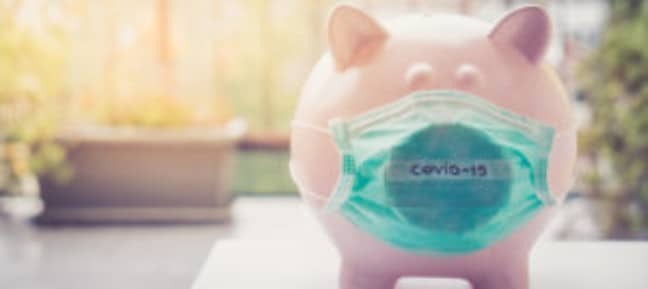 A piggy bank wears a face mask that reads "COVID-19." The CARES Act Coronavirus Economic Stimulus Package is designed to offset the financial impact of COVID19.