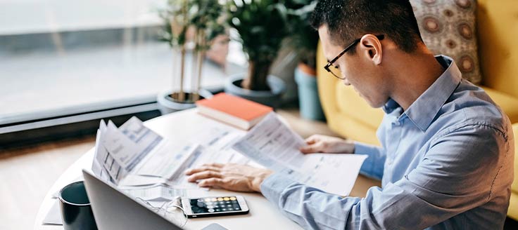 A man reviews documents at a table.