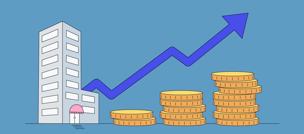 Image of a building with an upward trending line graph over it and 3 stacks of coins, stacked from shortest to tallest, to the right of it 