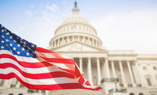 The Capitol Building with an American flag in the foreground