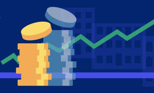 Stacked coins in front of a graph