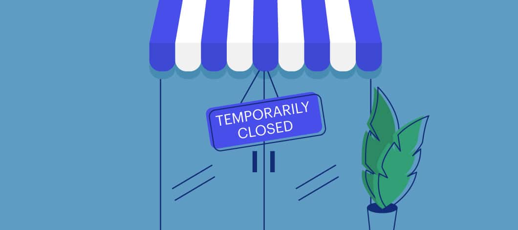 A sign on a glass door of a store reads “Temporarily Closed.”