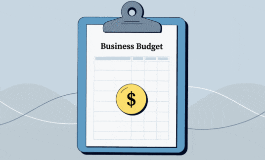 Moving image of a clipboard and a spreadsheet labeled “business budget” with a colorful pie chart and dollar sign in the middle