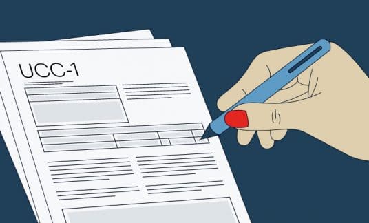 Person filling out UCC-1 form