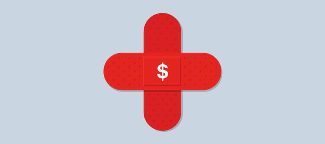 Two red bandages placed together in the shape of a cross with a dollar sign in the middle