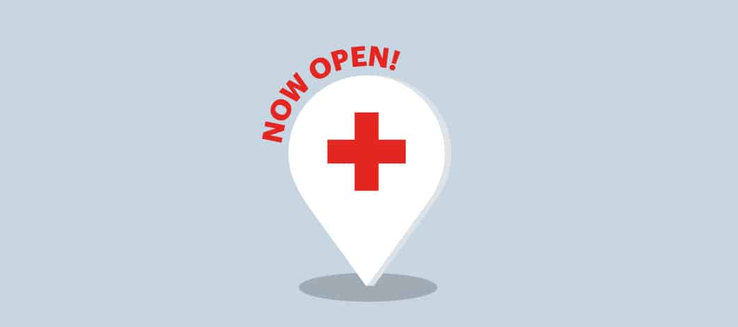 A teardrop shape with a red cross in the middle and the words "now open" above