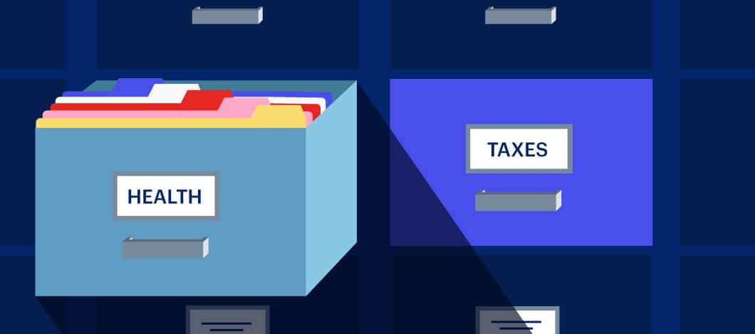 Two filing cabinet drawers, one labeled “health” and the other labeled “taxes” are side by side.