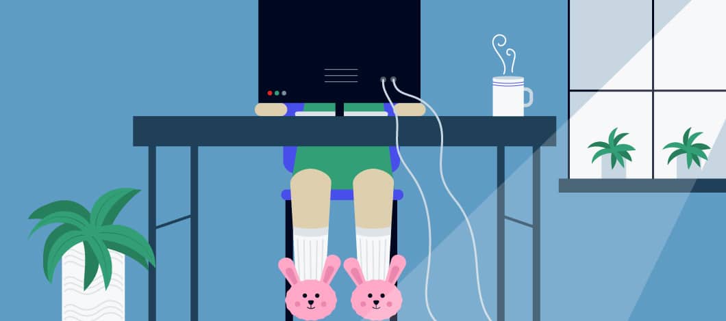 An employee working remotely from home sits at her desk. She’s wearing bunny slippers.