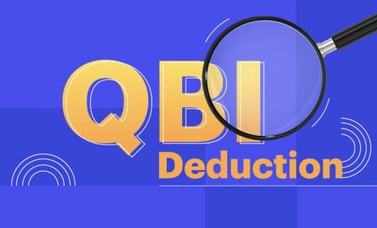 A magnifying glass inspects the words “QBI Deduction.”