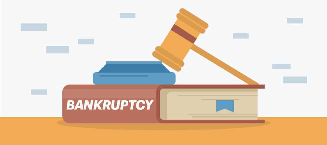 A gavel and block rest on a big book labeled “Bankruptcy.”