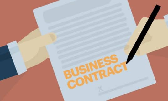 A person holds and signs a form labeled “Business Contract.”
