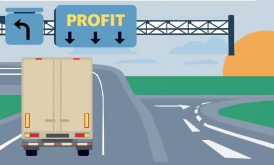 We see the back view of a cargo truck on a highway. A sign above reads “Profit.”