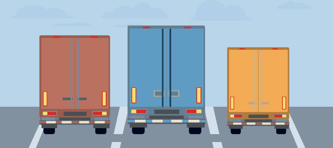 Three trucks haul cargo trailers on a highway.