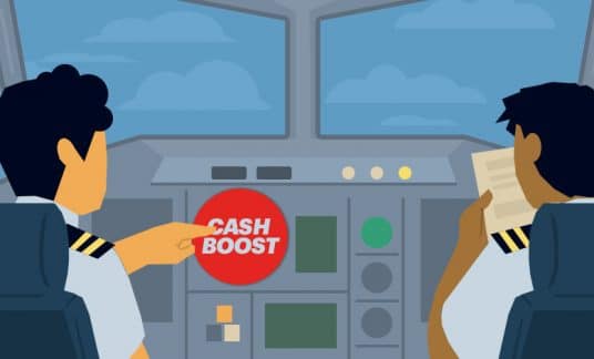 An airplane pilot in a cockpit is about to push a big bright red button labeled “Cash Boost.”