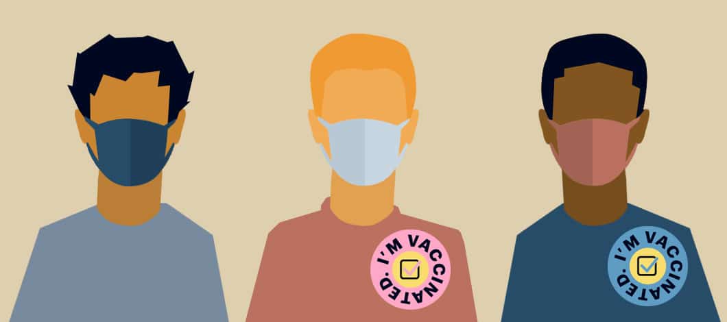 Three masked people stand apart. Two of them have “I”m Vaccinated” stickers on their shirts.