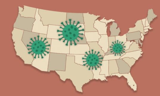 A map of the U.S. is dotted with the COVID-19 virus here and there.