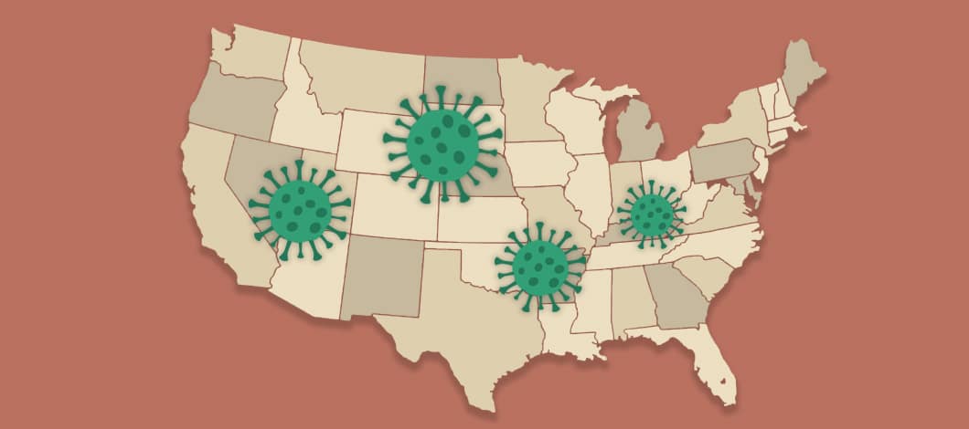 A map of the U.S. is dotted with the COVID-19 virus here and there.