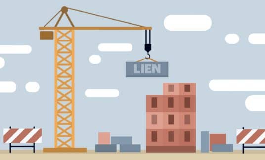 A crane lowers a cinder block labeled “Lien” to a building under construction.