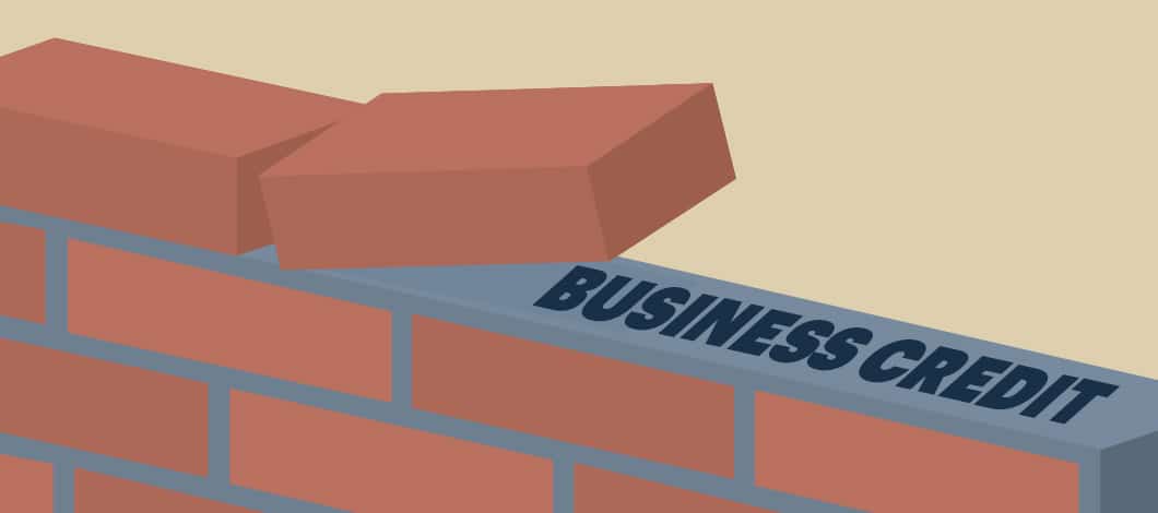 A brick-and-mortar wall is being built. Mortar on a layer under construction reads “Business Credit.