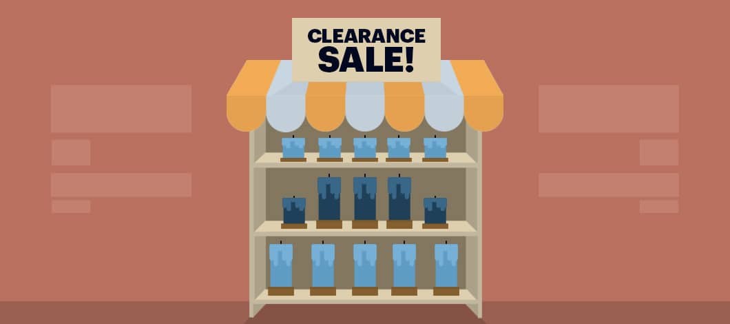 In a shop, shelves are filled with blue candles. There’s a sign that reads “Clearance Sale!”