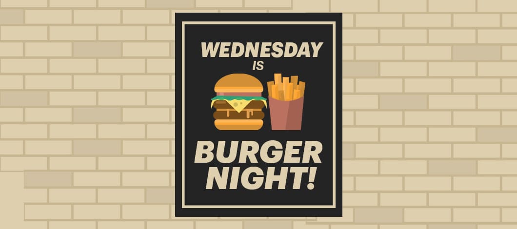 A banner hanging on a restaurant wall reads “Wednesday Is Burger Night!” There is an image of a burger and fries next to the words.