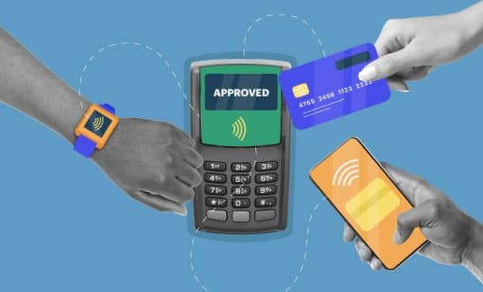 A hand with a smartwatch, a hand holding a credit card and a hand holding a cellphone demonstrate how to make a contactless payment with a payment-processing device.