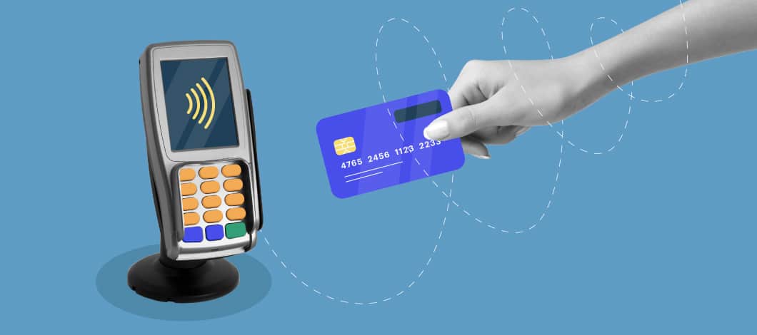 One hand holds credit card near a payment-processing device.