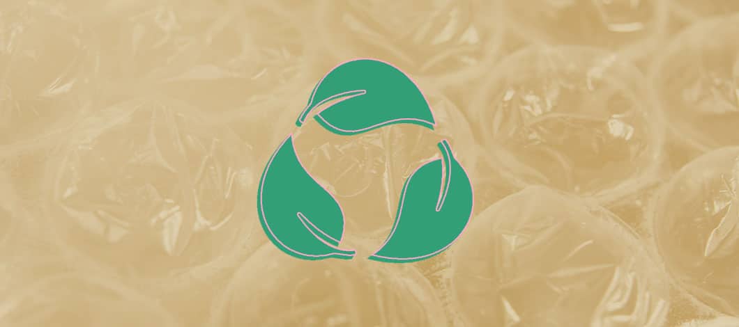 This is a close-up of bubble wrap with the biodegradable symbol in green.