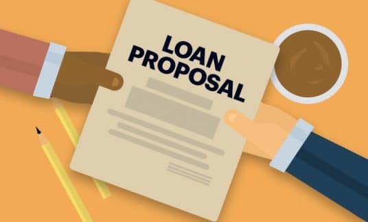 Across an office desk, one hand extends a document labeled “Loan Proposal” to another hand.