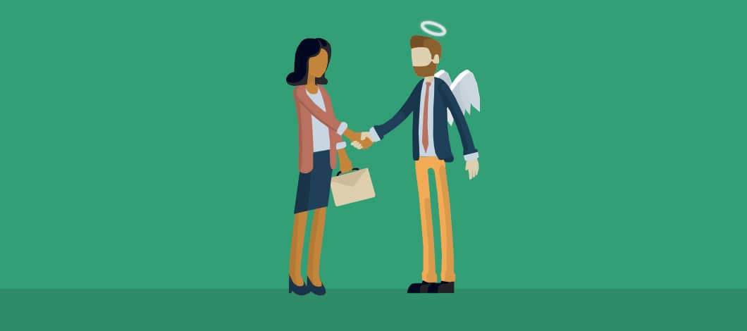 A businesswoman shakes hands with an angel investor, complete with wings and a halo.