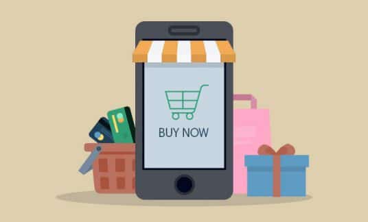 A smartphone is dressed up like a small shop. The screen has a shopping cart icon and reads “Buy Now.”