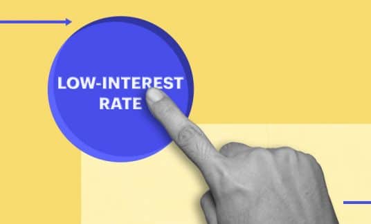 A finger presses a big button labeled “Low-Interest Rate.”