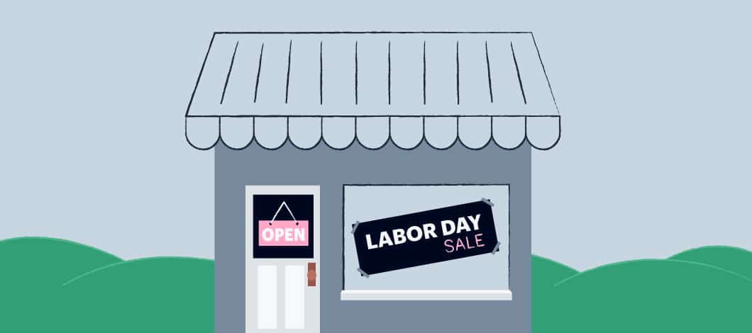 A small shop has a sign in the window that reads “Labor Day Sale.”